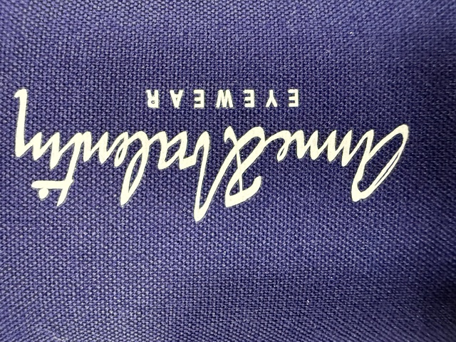 An Anne et Valentin eyewear case in violet canvas with the signature script logo