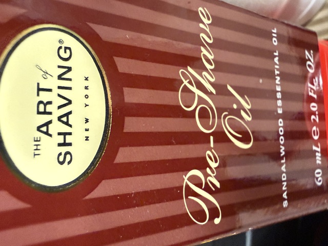 The Art of Shaving sandalwood pre-shave oil in its striped red box