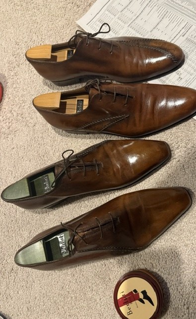 Two well-shined pairs of Berluti oxfords with the Berluti kit