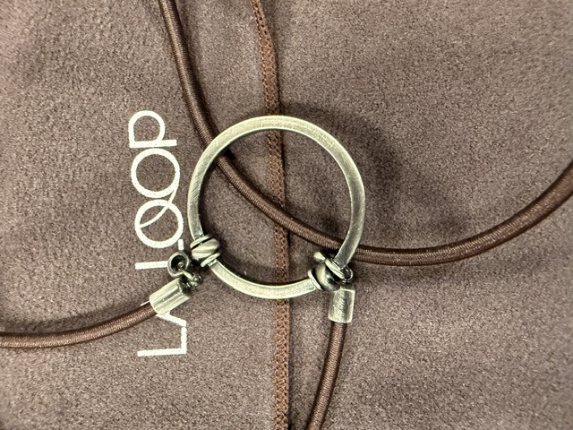 A LA LOOP eyeglass necklace in brown cord with a brushed silver loop