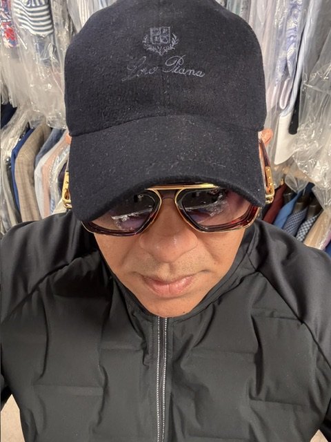 Chico in a navy Loro Piana wool cap and tortoiseshell navigator sunglasses, WSY Edit