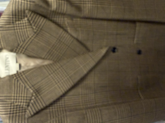 A Valentino glen check jacket with wide peak lapels sweeping up toward the shoulders